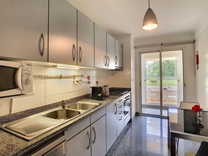 Enjoy a modern kitchen with a granite countertop, stainless steel appliances, and a double sink, perfect for preparing meals.