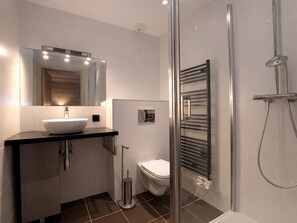 A modern bathroom with a glass-enclosed shower, a white sink, and a toilet. - Stunning duplex in Courchevel - 3 bedrooms, parking, WiFi (Courchevel)