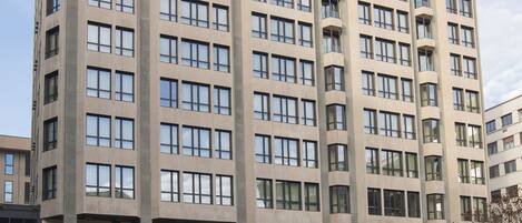 A multi-story building with a uniform facade, large windows, and a flat roof.