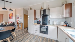 A modern kitchen with white cabinets, a built-in oven, and a microwave. - 2 Bed Cabin - Sleeps 4 - Pets - 5 min to Beach (Bridlington)