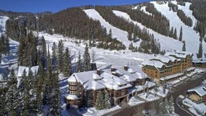 A ski resort with a large lodge and multiple buildings, surrounded by snow-covered slopes and trees. - Arguably the best ski in / ski out location in Whitefish!!! AC for hot days (Whitefish)
