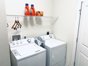 Convenient laundry facilities with two washing machines and a dryer.