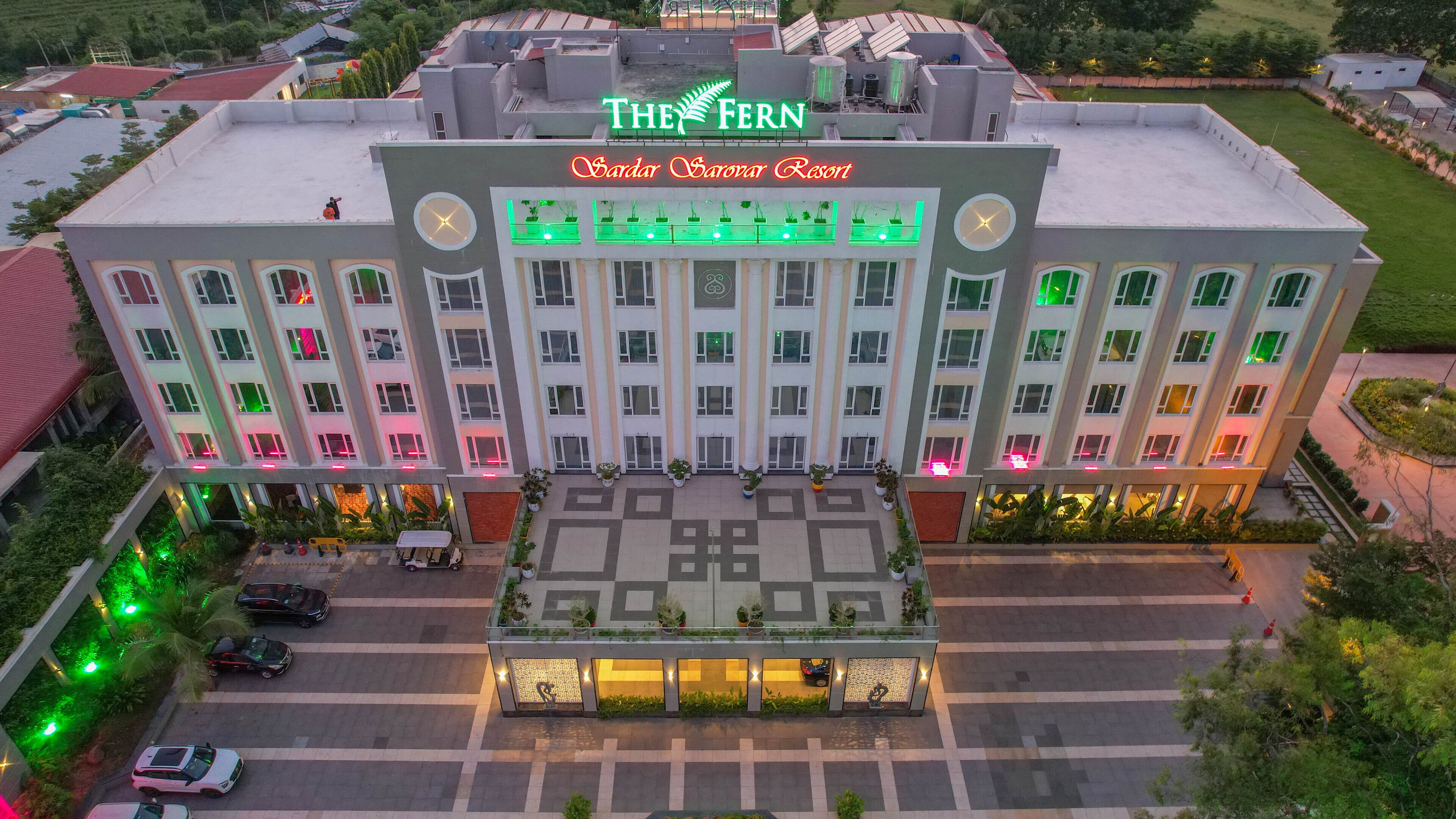 A multi-story hotel with a prominent sign reading "The Fern" and "Sarda Sarovar Resort".
