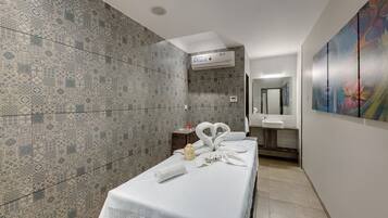 Relax in a stylish room with a patterned tile accent wall, a comfortable bed, and a convenient nightstand.