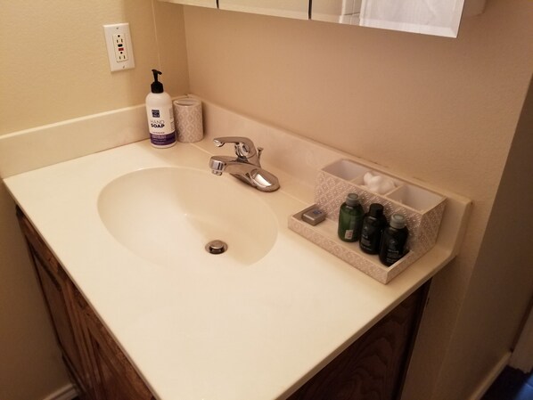 A bathroom sink with a faucet, a soap dispenser, and a soap dish. - Perfect For Travelers and Traveling Nurses Near I-20 (Odessa)