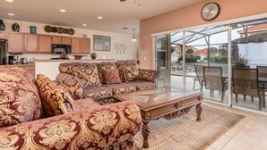 A spacious living area with a sofa set, a coffee table, and a dining table with chairs. - Aviana Resort-ru1077 (Davenport)