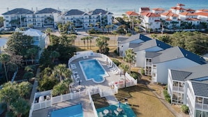 A resort with a pool area, multiple buildings with red-tiled roofs, and a view of the ocean. - Gulf view, Pool, Deed Beach Beach Access in Santa Rosa Beach.  (Santa Rosa Beach)