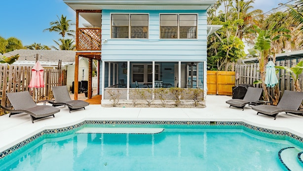 A two-story house with a swimming pool, outdoor furniture, and a wooden deck. - Heated Pool, 4 Houses to Beach (Siesta Key)