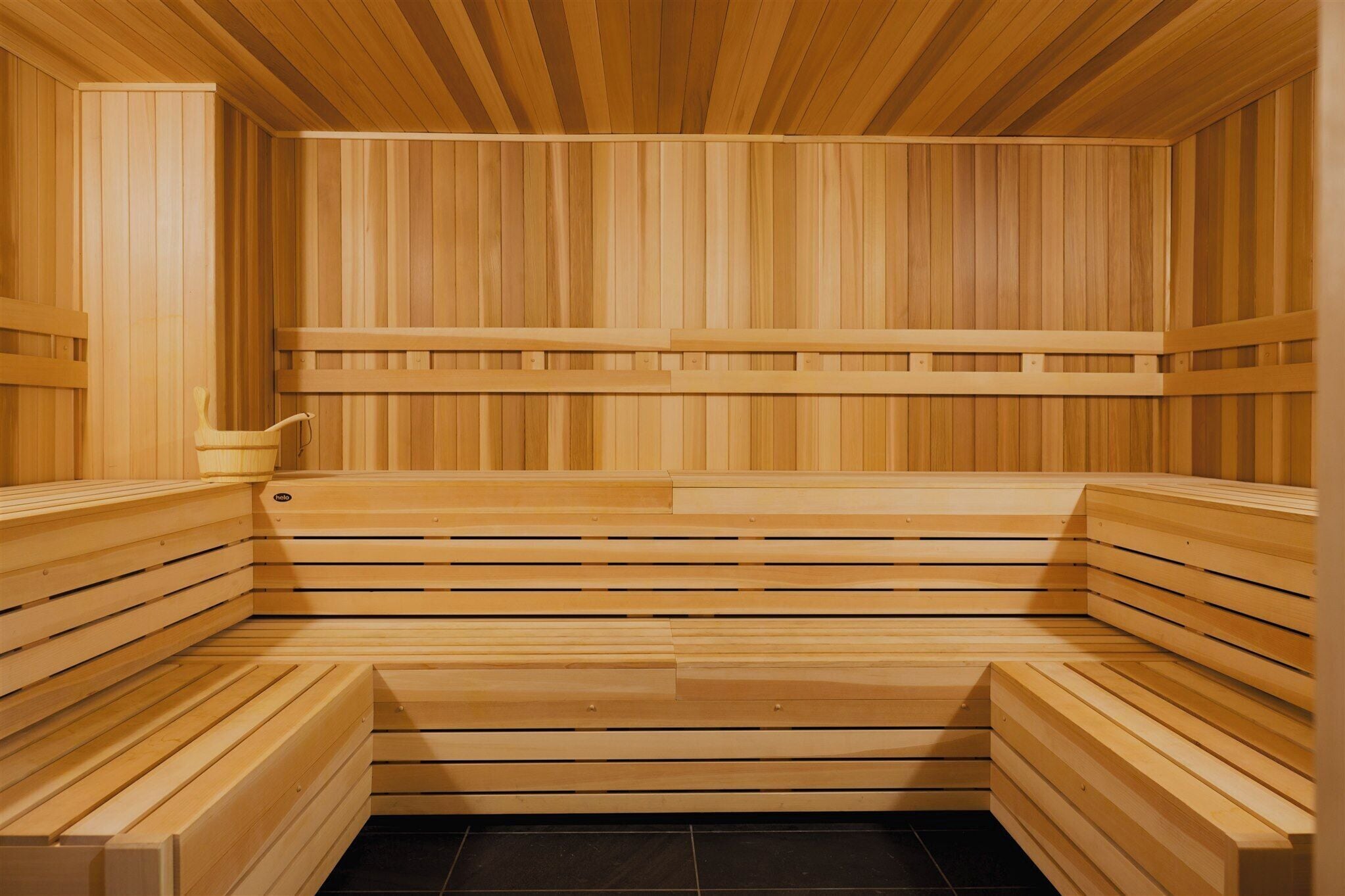 A wooden sauna with benches and a bench seat.