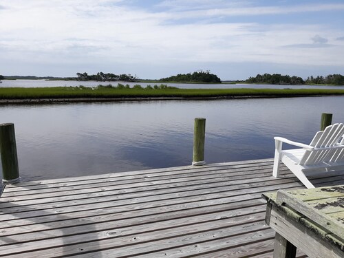 View of intracoastal waterway with private dock and boat lift.
