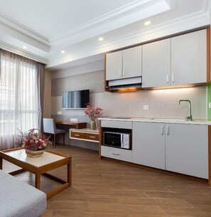 A modern apartment with a sofa, a dining area, and a kitchen. - Vinh Saigon SECC 2 (Ho Chi Minh City)