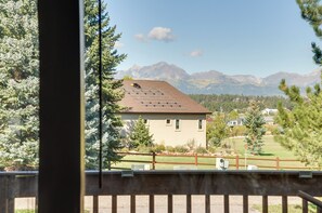 A house with a sloped roof, surrounded by a fenced yard and trees. - SoCo Pagosa Lakes Cabin w/ Deck & Grill! (Pagosa Springs)