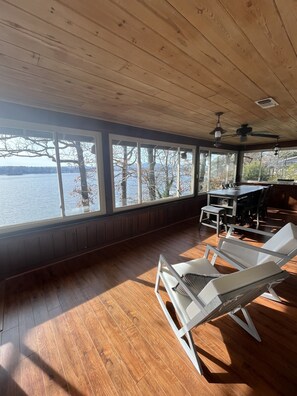 A room with large windows, wooden flooring, and a ceiling fan. - Incredible PANORAMIC Lake House View 3 mi. to Oaklawn (Hot Springs National Park)