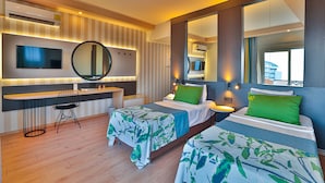 A hotel room with two beds, a desk, a mirror, and a TV. - Crystal Land Of Paradise Beach Hotel (Alanya)