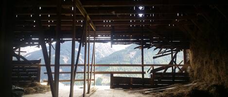 A rustic wooden structure with a view of mountains.