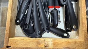 A drawer containing various kitchen utensils including spatulas, a whisk, and a grater. - Just Like Being At Home- Newly Renovated Unit (North Troy)