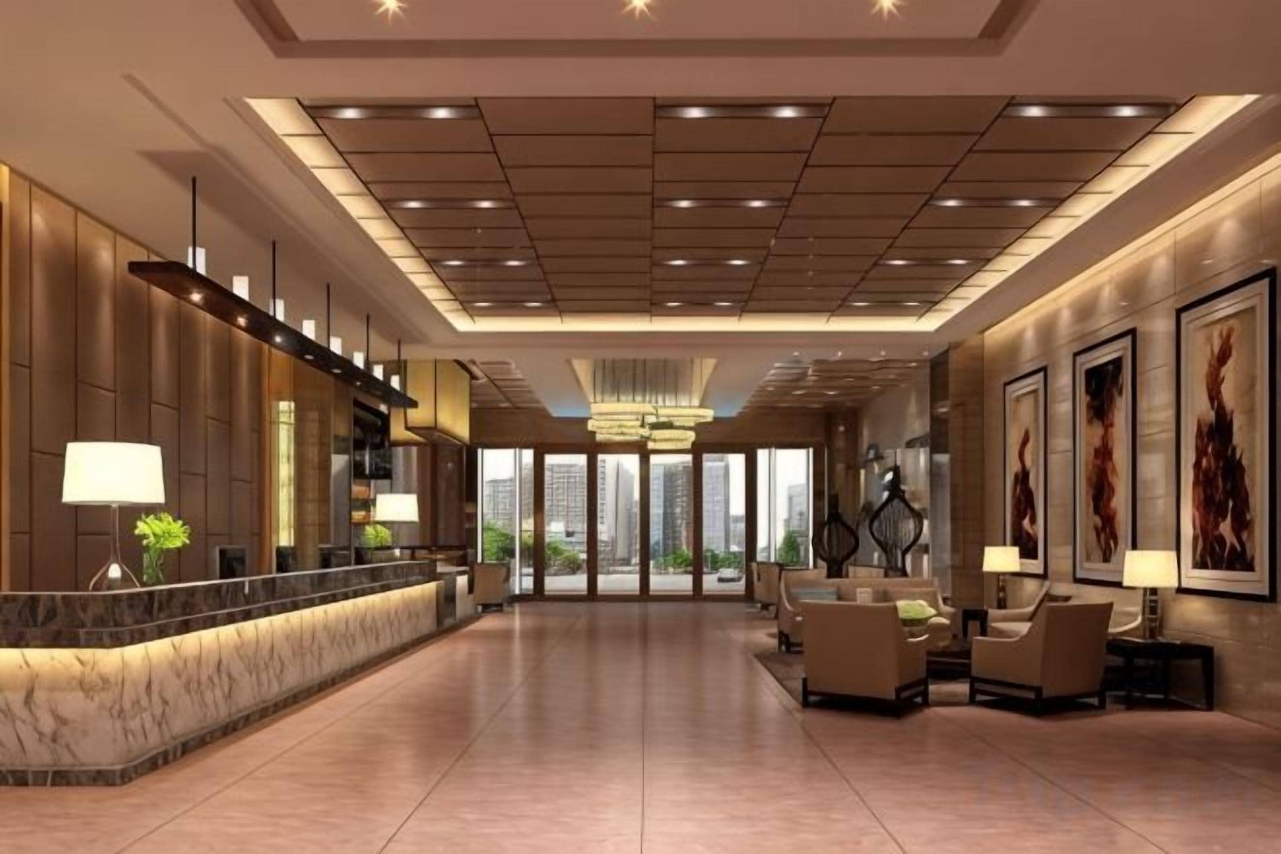 A hotel lobby with a reception desk, seating area, and large windows.