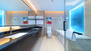 A modern bathroom with a glass shower enclosure, a large mirror, and a dual sink vanity.