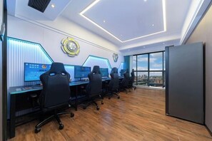A modern office with multiple workstations, a large window with a city view, and a unique ceiling design. - Perthden (Hanging) Gardens Hotel (Shenzhen)