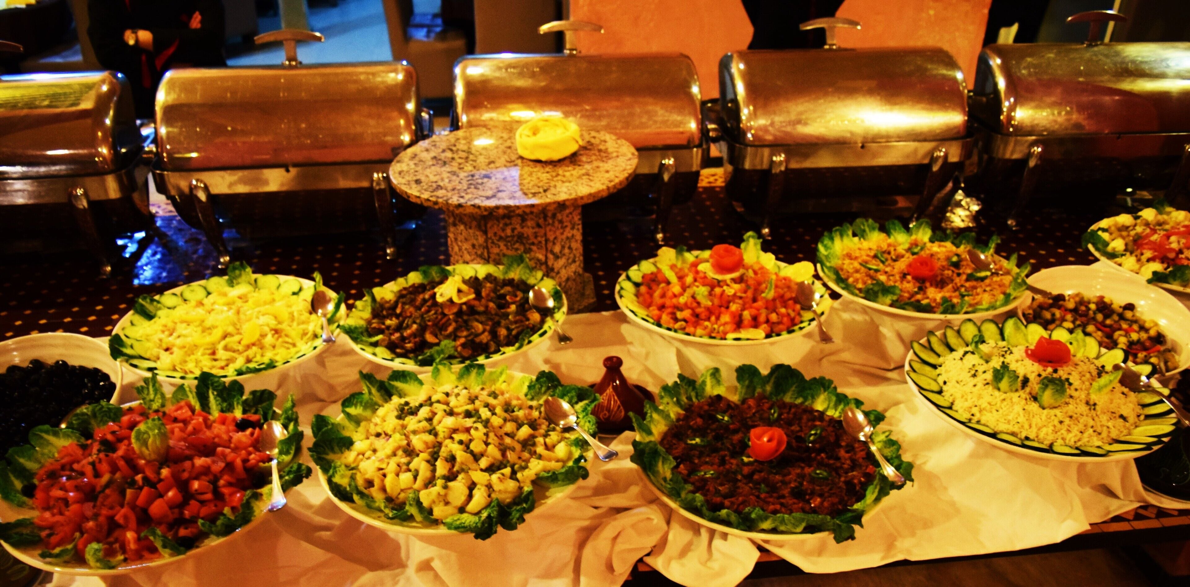 A buffet table with various dishes.