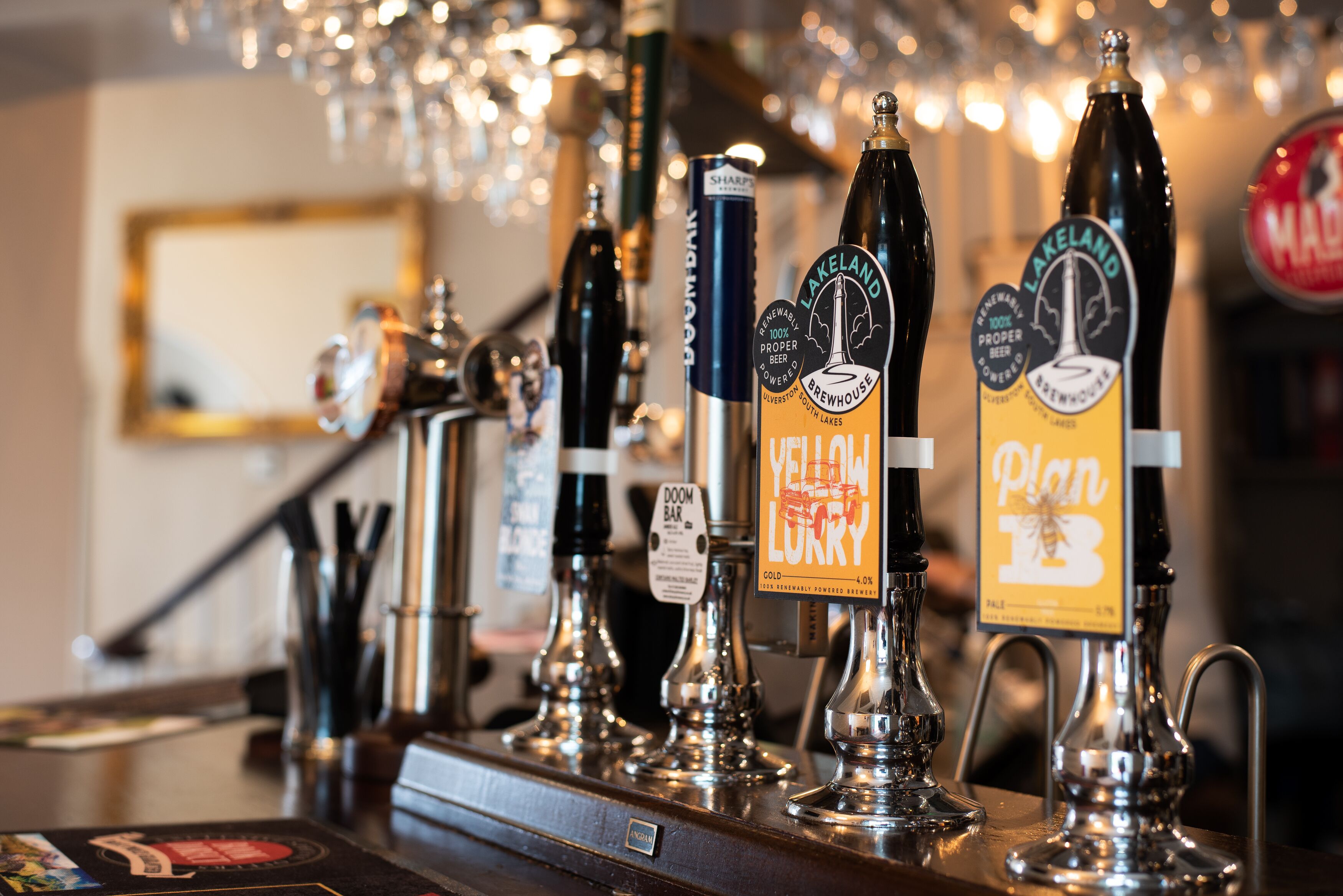 A bar with multiple taps, including brands like 'Yellow Lurry' and 'Lakeland Brewery'.