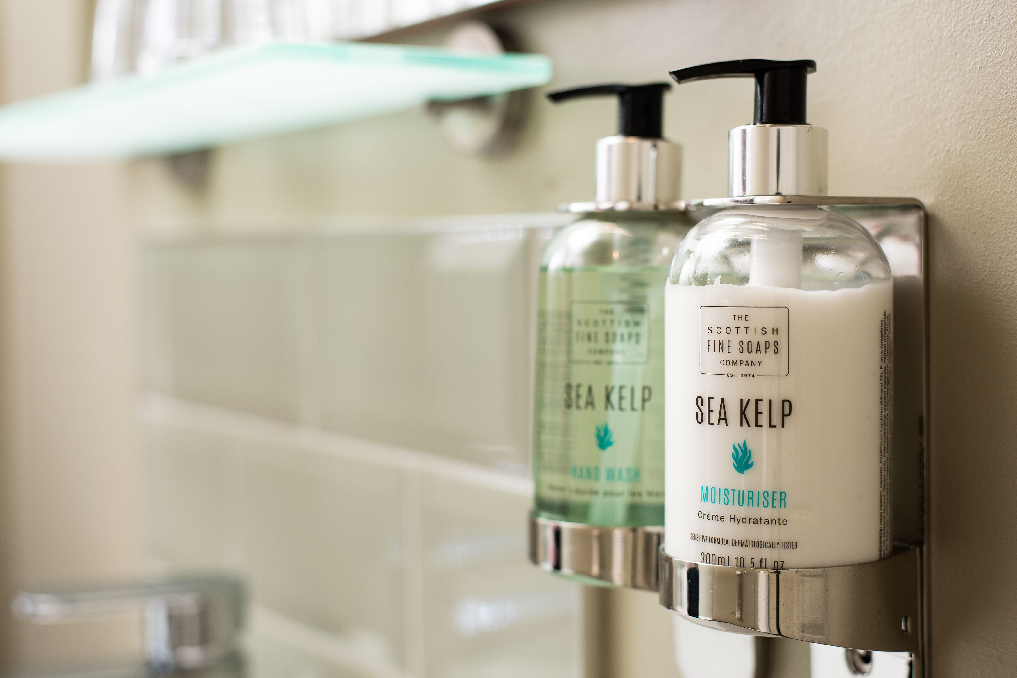 Two Sea Kelp hand wash bottles mounted on a wall.