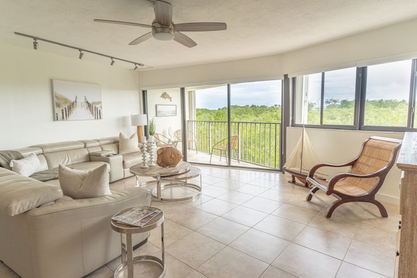 Living room showing the balcony & wall to wall windows