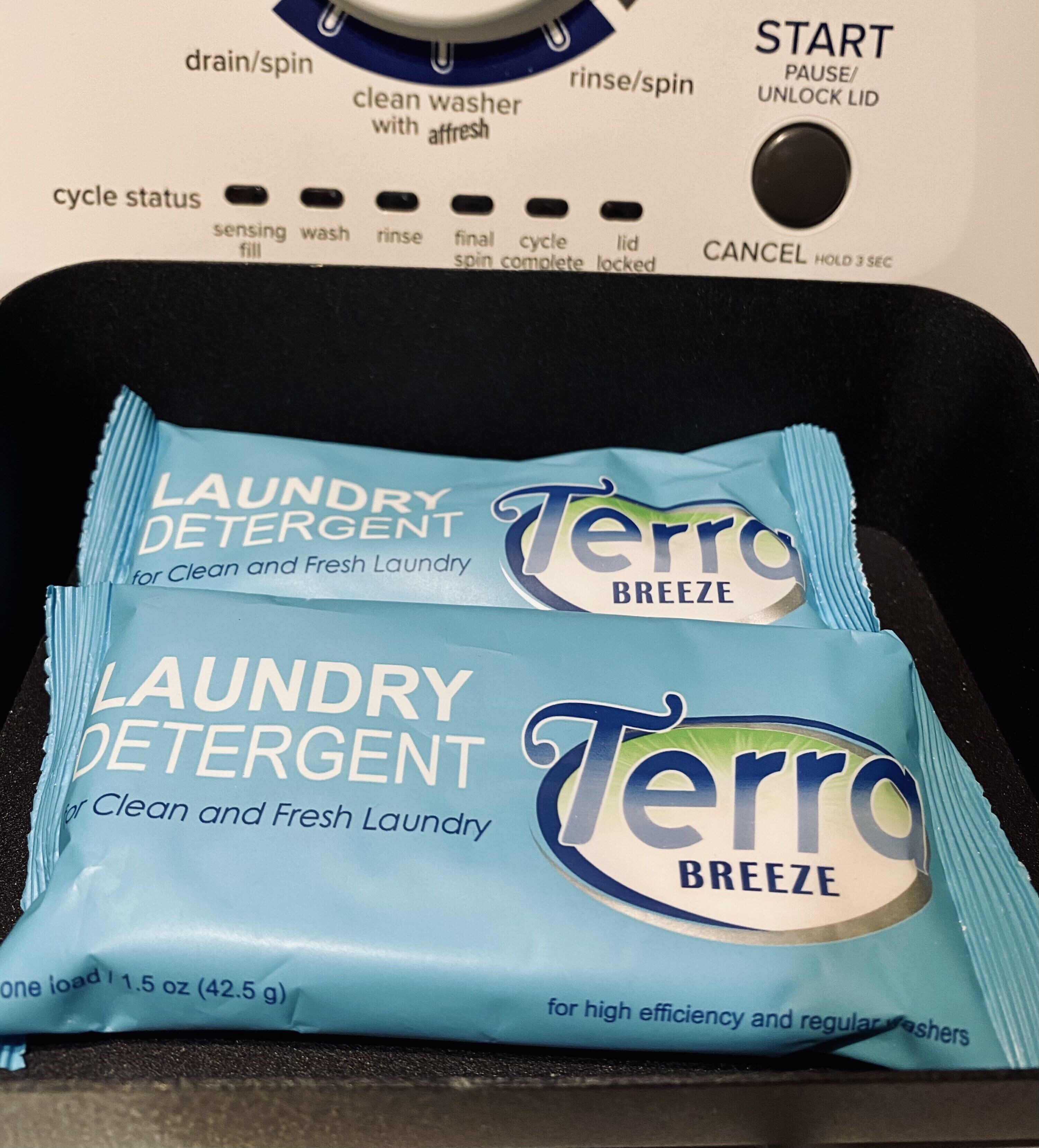 A washing machine with a detergent packet labeled 'Terro Breeze' for clean and fresh laundry.
