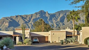 A modern building with a garage and a car parked in front. - Central Tucson Gated Retreat (Tucson)