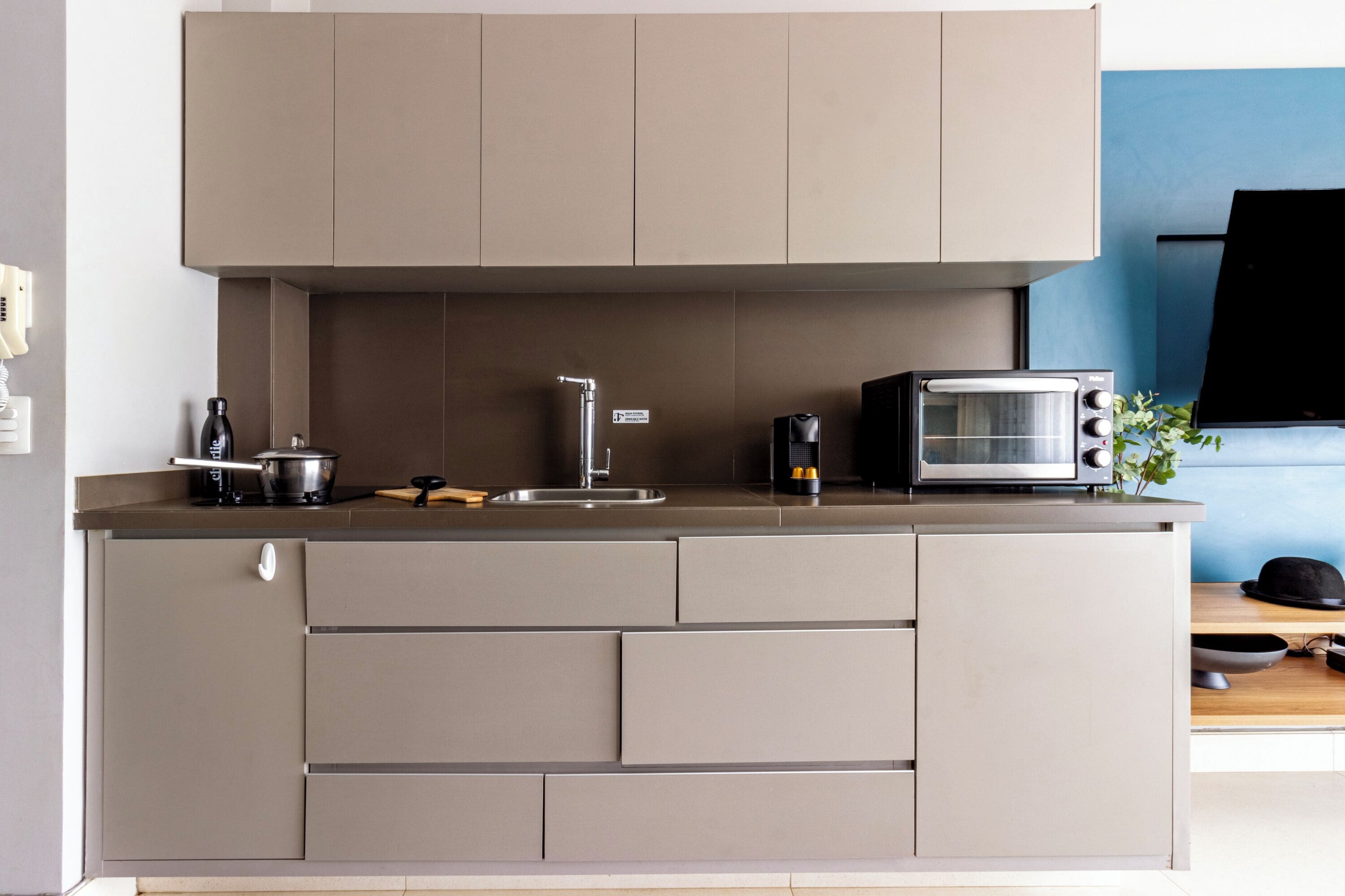 A modern kitchen with a built-in stove, a coffee maker, and a toaster.