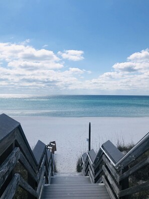 A wooden staircase leading to a beach with a clear sky and calm sea. - Mermaid Manor - views and only steps to the walkover to the white sandy beach! (Destin)