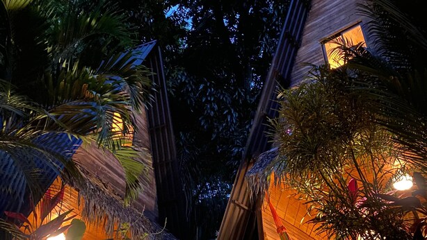 A tropical resort with thatched-roof huts surrounded by lush vegetation. - Buena Onda - Bungalow Hermosa few steps to the beach (Playa Hermosa)