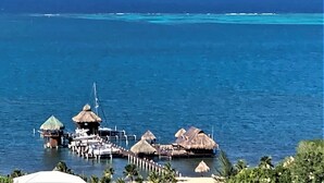 A coastal resort with overwater bungalows, a pier, and a clear view of the ocean. - Stunning Turquoise views from this 2 bedroom, 2 bath home... (roatan)
