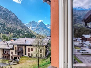 A mountain view with a building in the foreground.