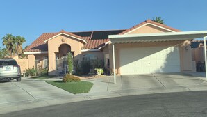 A residential house with a garage, a driveway, and a well-maintained lawn. - Private Studio, own entry, kitchenette,  full bath. (North Las Vegas)