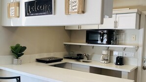 A kitchen with a white countertop, a coffee maker, a microwave, and a sign that says "Home Sweet Home". - Private Studio, own entry, kitchenette,  full bath. (North Las Vegas)