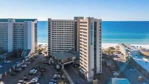 A hotel with multiple high-rise buildings, a parking lot, and a beach view. - High-Floor 1BR Condo With Gulf Views, Balcony and Sleeps 4 (Destin)