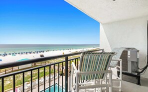 A balcony with a pool, beach view, and air conditioning unit. - SunDestin 1BR Gulf-Front Condo With Cheerful Coastal Charm - Unit 0407 (Destin)