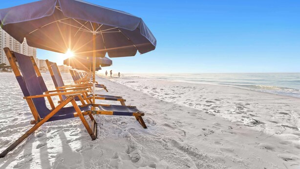 A beach with sun umbrellas and lounge chairs. - SunDestin 1BR Condo With Gulf-Front Sunrise and Sunset Views - Unit 0618 (Destin)