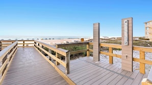 A wooden boardwalk leading to a beach with a clear sky. - SunDestin 2BR Beach Condo With Modern Updates and Spacious Layout - Unit 0218 (Destin)