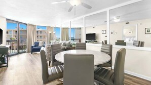 A modern hotel room with a large balcony, a round dining table, and a TV. - SunDestin 1BR Condo With Spacious Layout and Sleeps 6 - Unit 0314 (Destin)