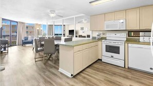 A modern kitchen with a central island, built-in appliances, and a dining area with a view. - SunDestin 1BR Condo With Spacious Layout and Sleeps 6 - Unit 0314 (Destin)