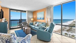 A spacious living room with a large balcony overlooking the beach, a comfortable sofa set, and a flat-screen TV. - SunDestin High-Floor 2BR Condo With Gulf Views and Private Balcony (Destin)