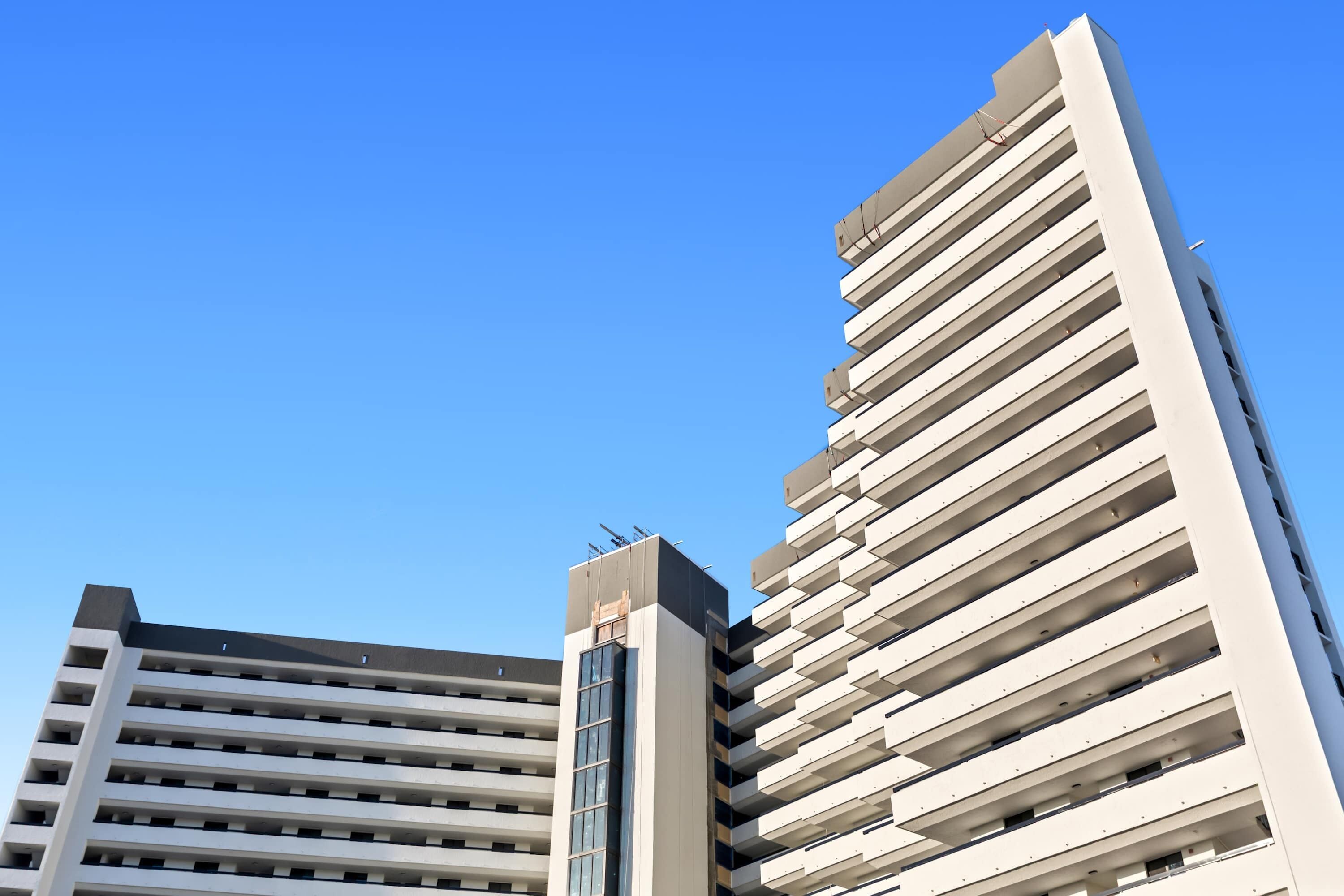 Two high-rise buildings with a clear blue sky.