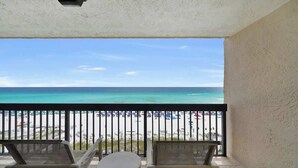 A balcony with a view of a beach and ocean. - Destin 1BR Beachfront Getaway With Comfortable Gulf-View Living (Destin)