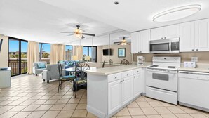 A spacious kitchen with white cabinets, a central island, a microwave, and an oven. - SunDestin Beach Retreat With Spacious Balcony Seating for 4 - Unit 0317 (Destin)