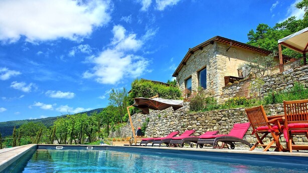 A swimming pool with lounge chairs and umbrellas, surrounded by stone walls and a stone building with a window. - Villa Ancora - House with private pool (Cercina)