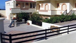 Un edificio de dos pisos con un balcón y una escalera.