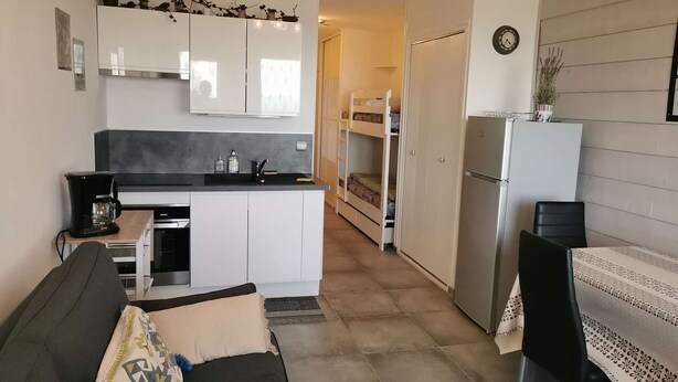 A compact living space with a kitchenette, a dining area, and a bunk bed. - Renovated Studio - South Balcony - 6 Pers - Ski/Hike (Saint-Michel-de-Chaillol)
