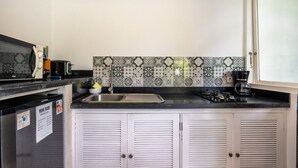 A kitchen with a sink, a coffee maker, and a mini bar sign. - Romantic Jungle Villa, 1 BR, Ubud With Staff (Ubud)